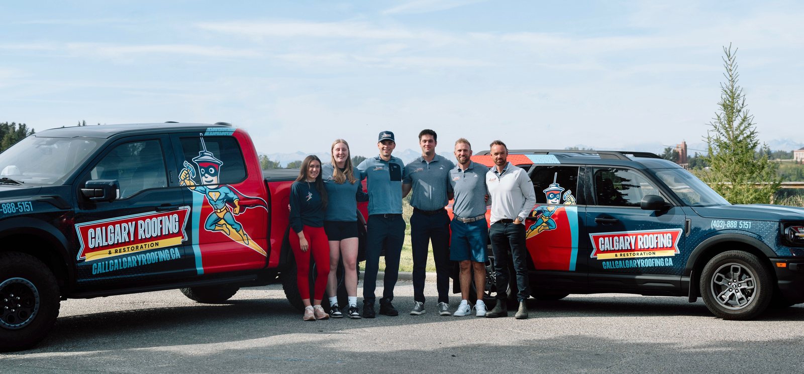 The Calgary Roofing and Restoration team with company vehicles